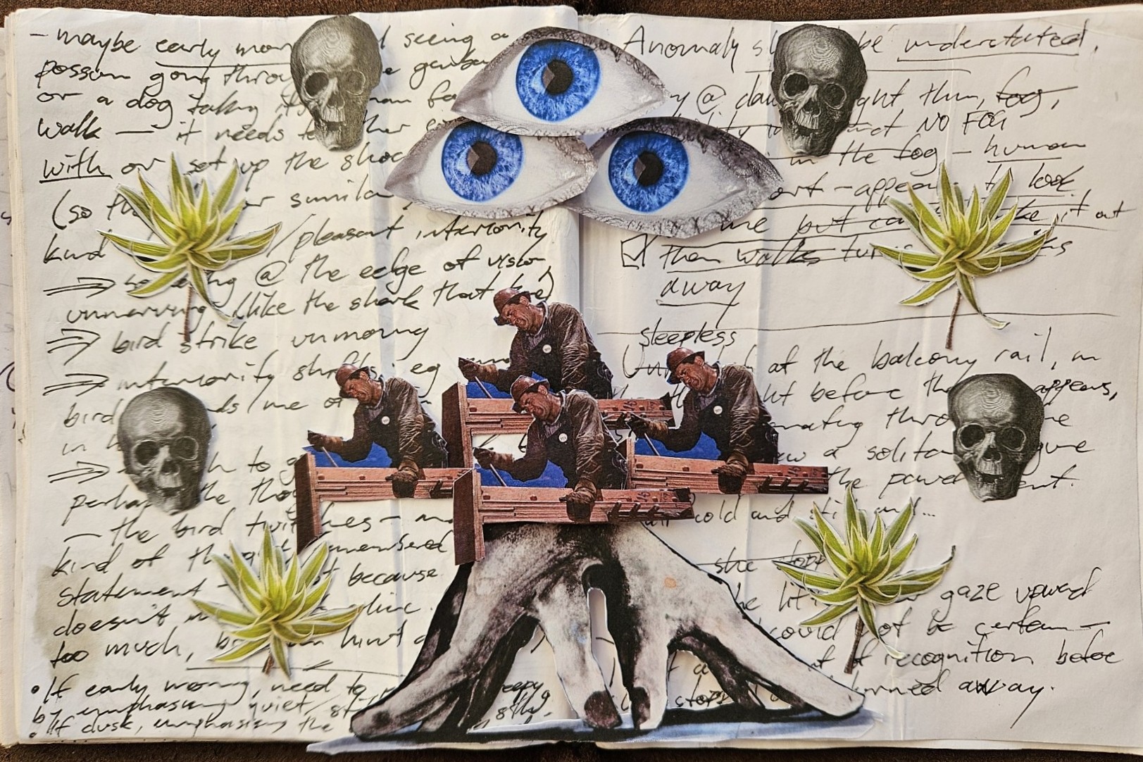 A collage on an open notebook page filled with handwritten notes. Cut-out images are arranged over the writing: three large blue eyes overlapping near the top, several small skull illustrations around the page, plant cut-outs resembling pleomele, and a repeating series of identical men working with tools on a wooden beam. At the bottom, there is a cut-out image of a monstrous hand emerging from the lower edge. The background handwriting remains visible behind all elements.